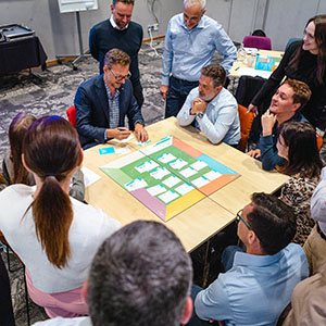 People playing CELEMI Enterprise™ business simulation in a room