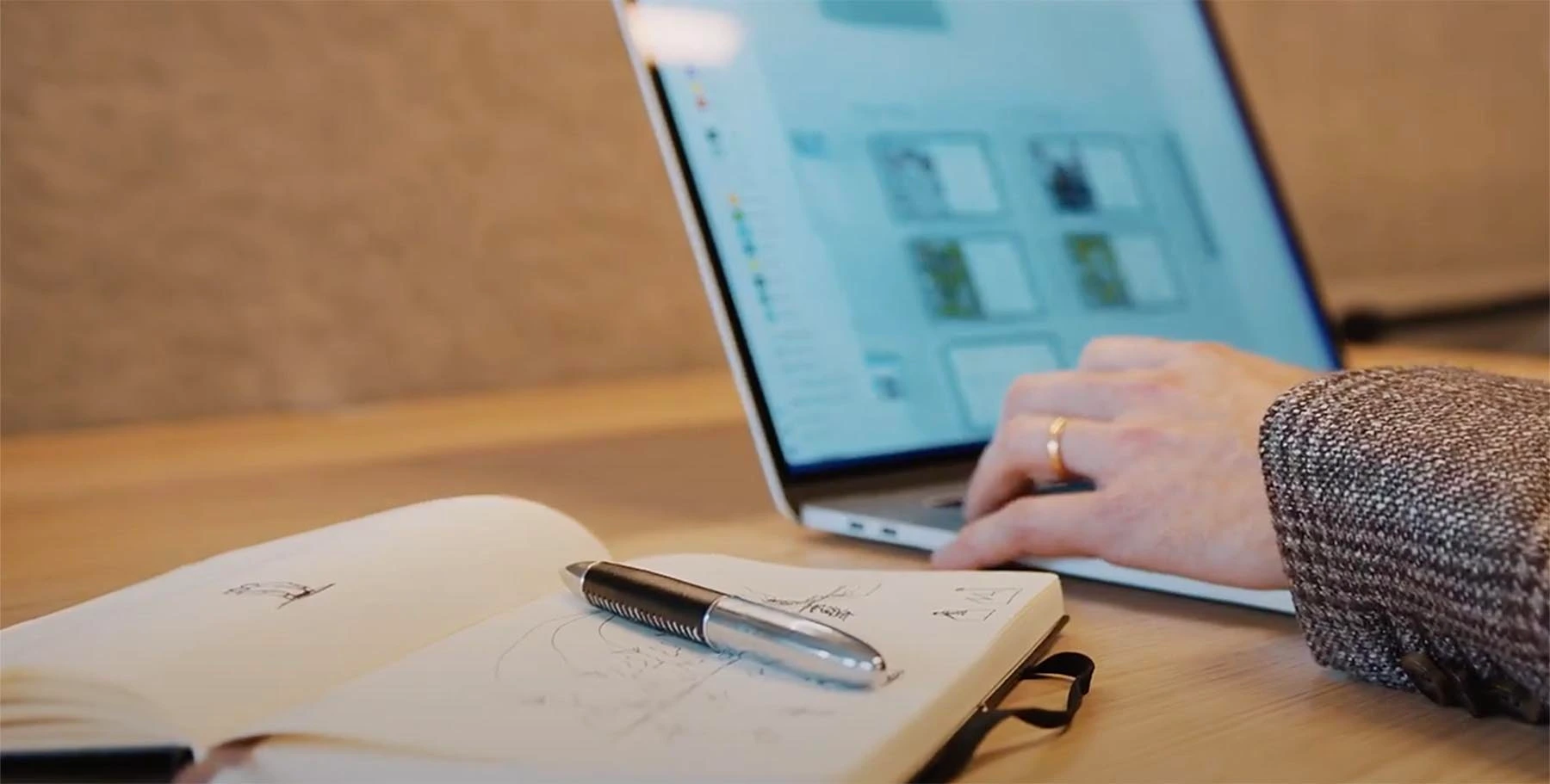 Close-up of a Celemi designer with a laptop